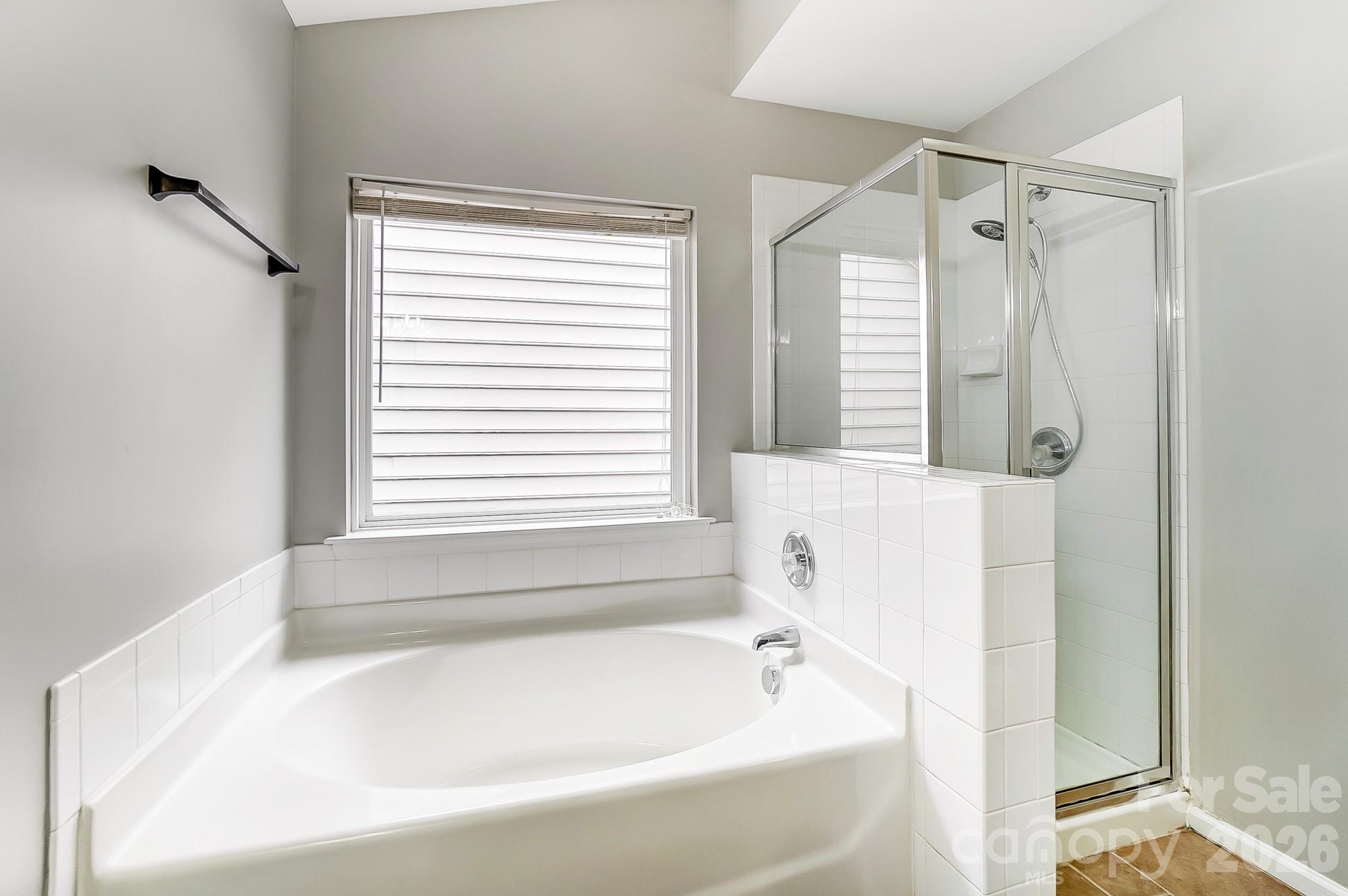 4914 Sunset Ridge Court Charlotte, NC 28269 - Photo 30 of 48 a white bath tub sitting next to a window