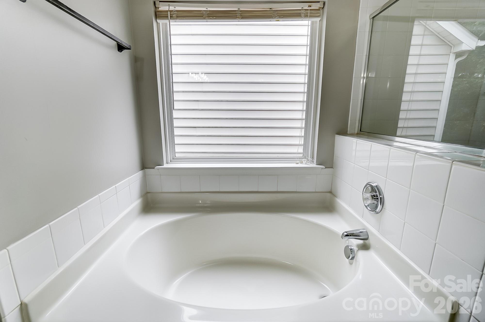 4914 Sunset Ridge Court Charlotte, NC 28269 - Photo 32 of 48 a white bath tub sitting under a window