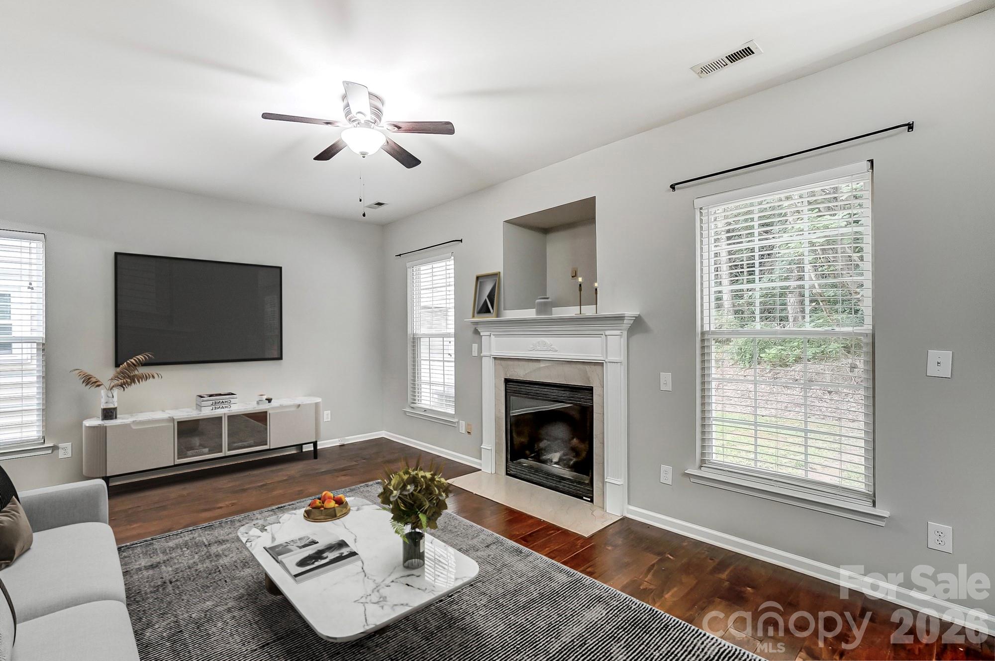 4914 Sunset Ridge Court Charlotte, NC 28269 - Photo 5 of 48 a living room with furniture a flat screen tv and a fireplace