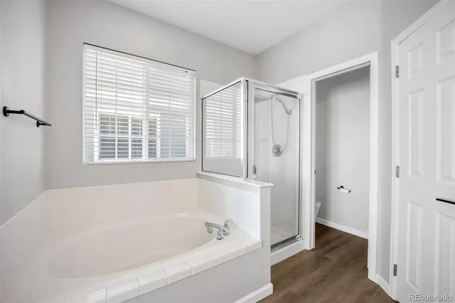 a white bath tub sitting in a bathroom next to a window