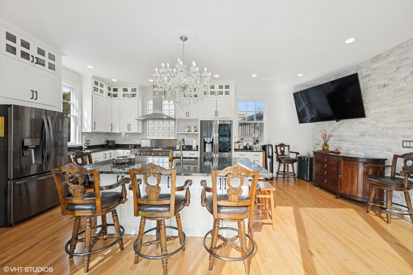 130 Michaux Road Riverside, IL 60546 - Photo 12 of 45 a view of a dining room with furniture a kitchen and chandelier