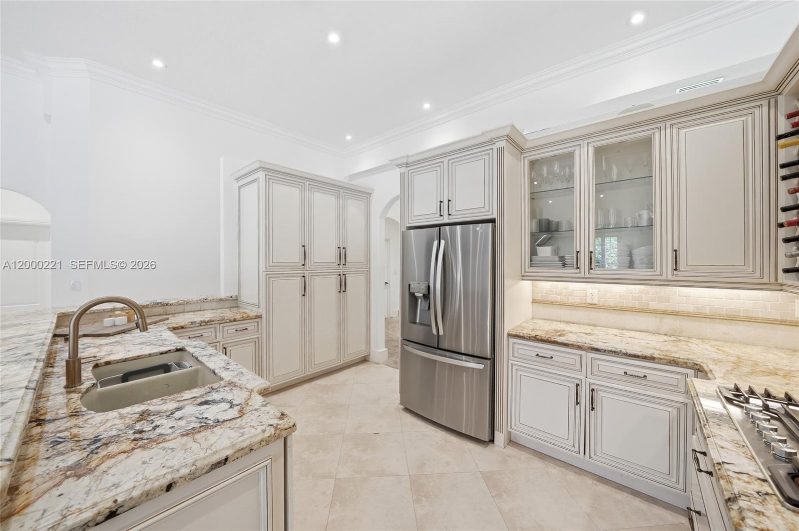 9901 Southwest 145th Street Miami, FL 33176 - Photo 17 of 78 a kitchen with granite countertop a refrigerator sink stove and cabinets