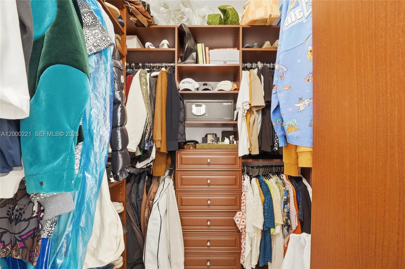 9901 Southwest 145th Street Miami, FL 33176 - Photo 36 of 78 a view of walk in closet with clothes and shoes