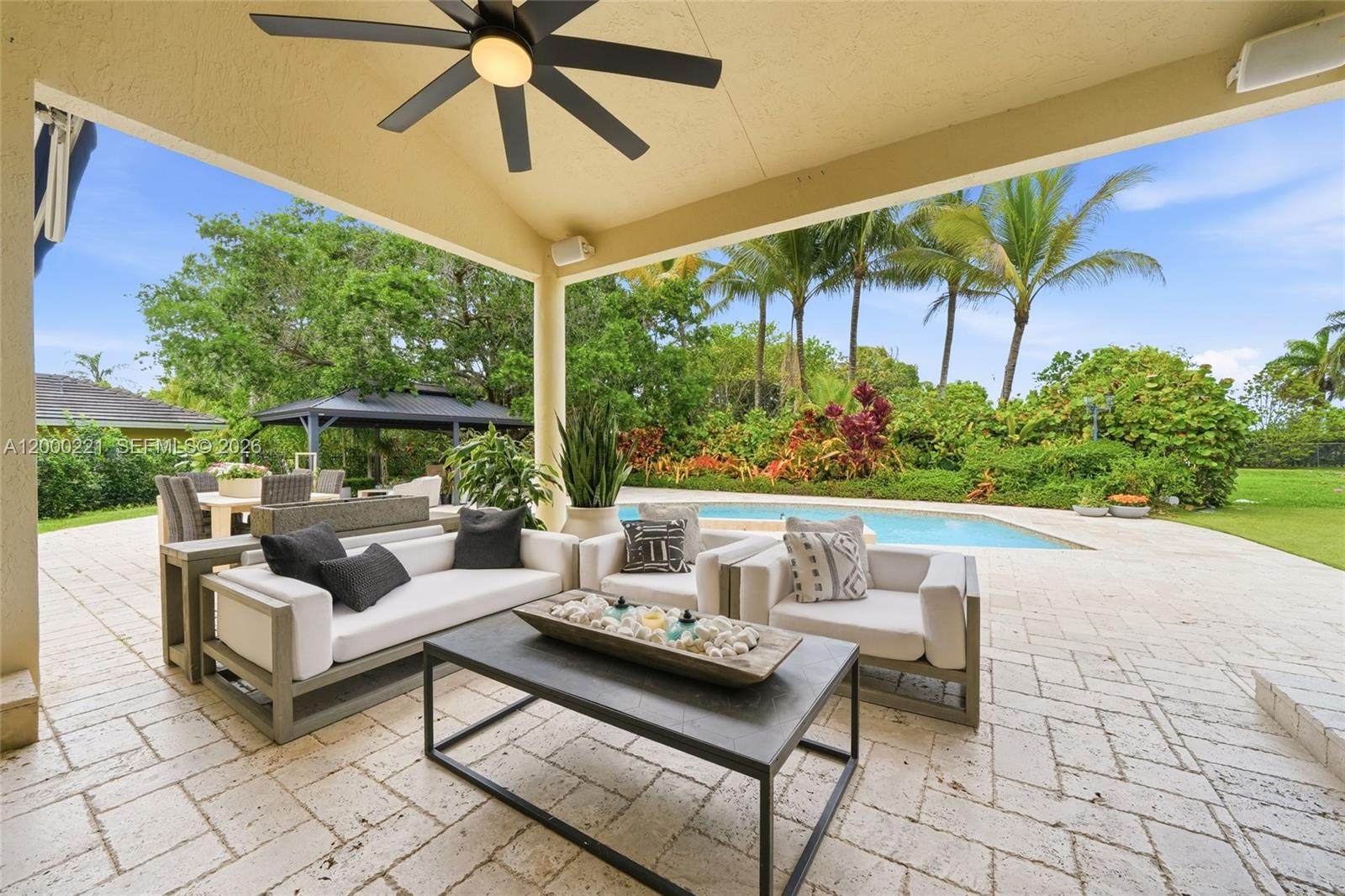9901 Southwest 145th Street Miami, FL 33176 - Photo 38 of 78 a living room with patio furniture and a garden