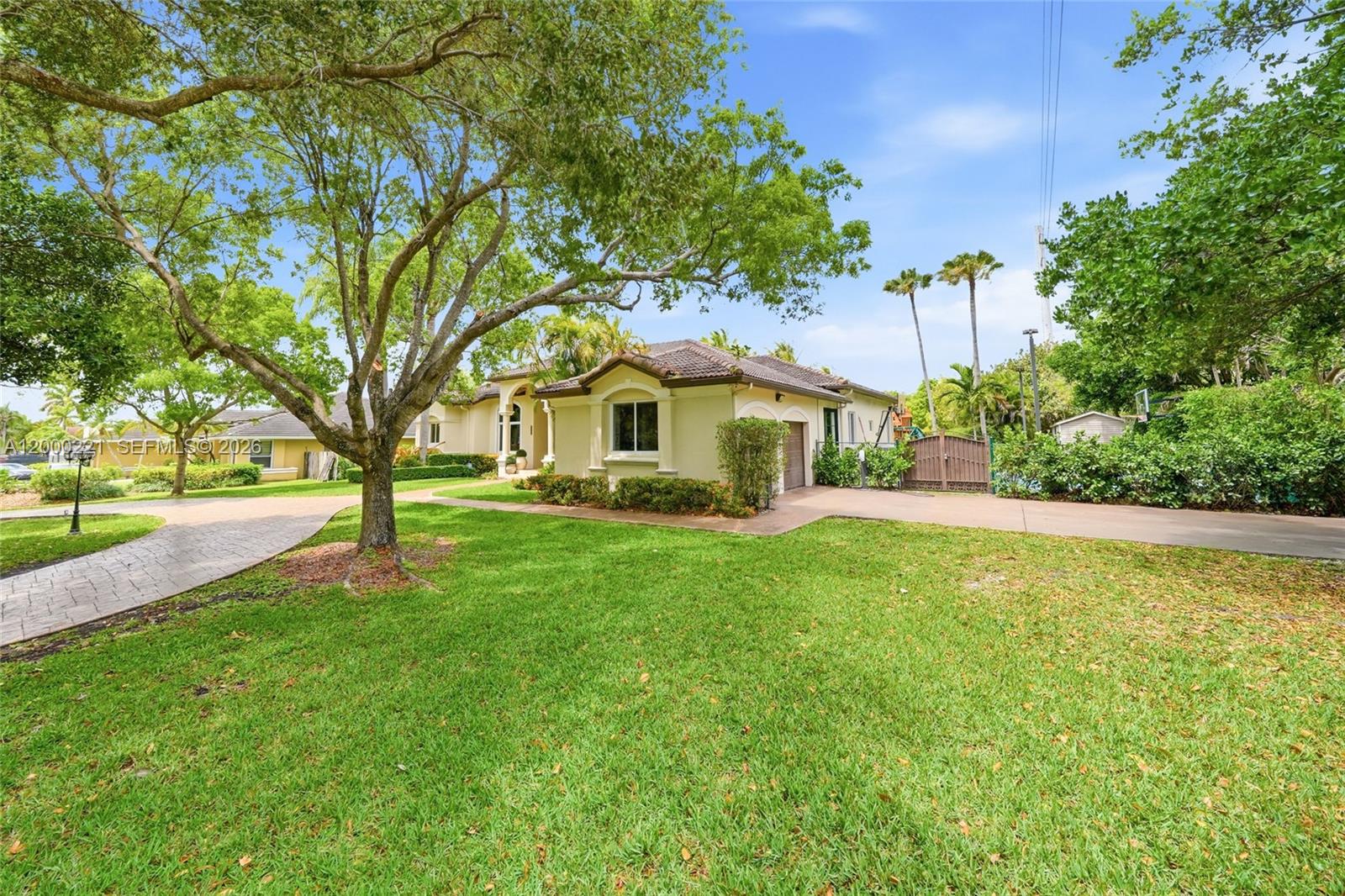 9901 Southwest 145th Street Miami, FL 33176 - Photo 4 of 78 a front view of a house with yard and green space