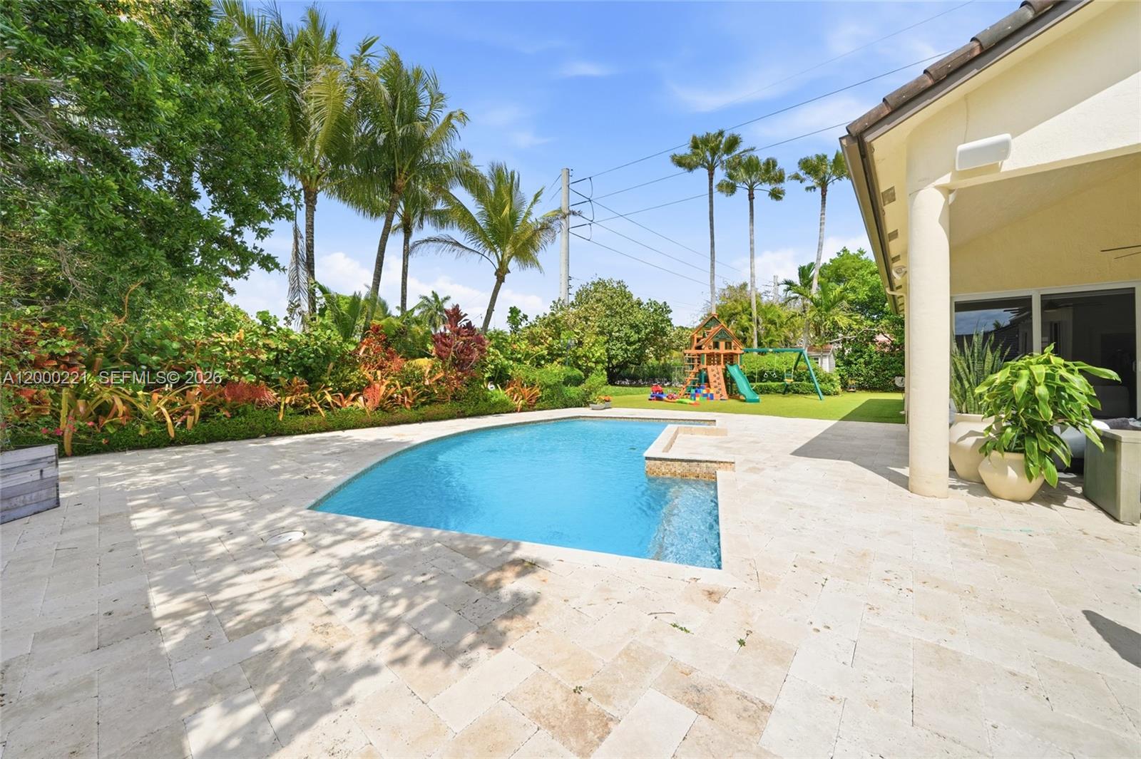 9901 Southwest 145th Street Miami, FL 33176 - Photo 41 of 78 a view of a swimming pool with a patio