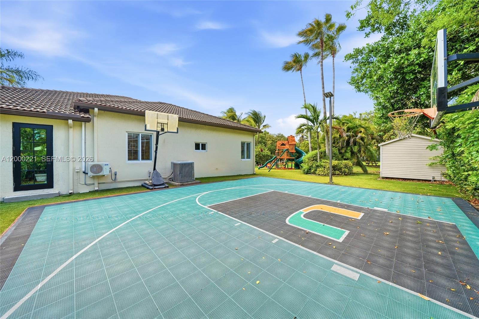 9901 Southwest 145th Street Miami, FL 33176 - Photo 43 of 78 a view of a house with a backyard and a tree