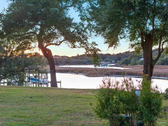 a dining room with furniture a chandelier and wooden floor