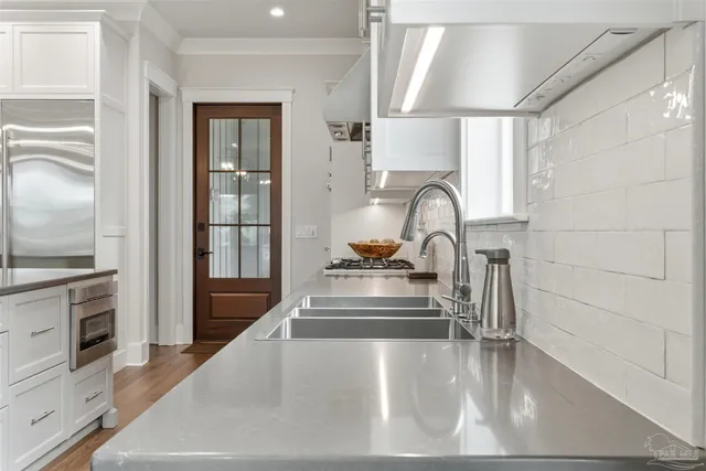 a bedroom with a bed and a flat tv screen on dresser