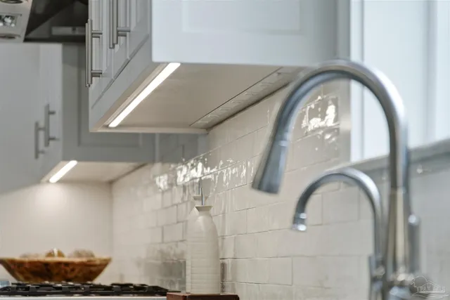 a view of a livingroom with a furniture and chandelier fan