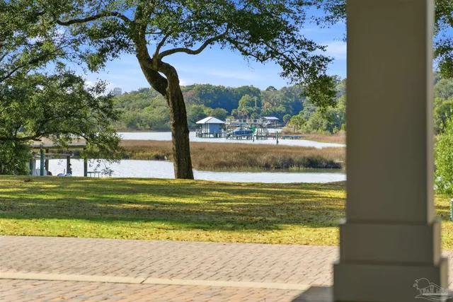 a living room with furniture kitchen view and a chandelier
