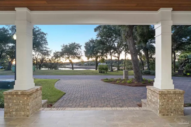 a living room with fireplace furniture and a large window