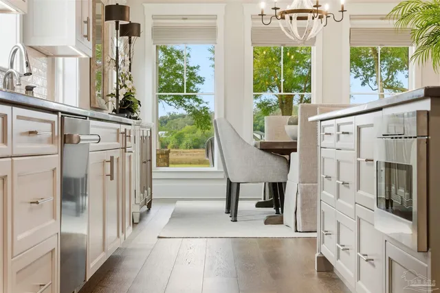 a view of a hallway with furniture and wooden floor