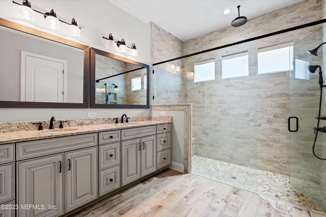 a spacious bathroom with a granite countertop sink mirror and double