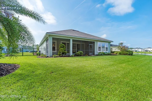 a view of a house with a yard and sitting area