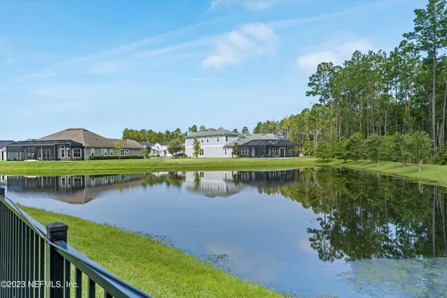 a view of a lake with houses in the back