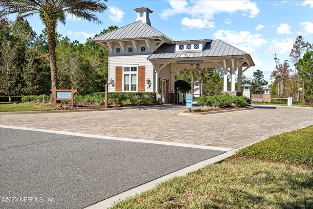 a view of a house with a yard and potted plants