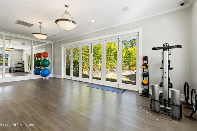 a view of a tennis ground with large trees
