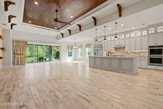 a view of a kitchen with cabinets and wooden floor