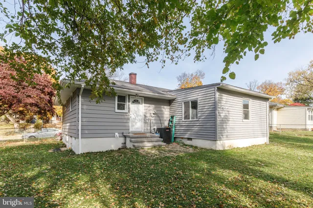 a backyard of a house with a table and chair