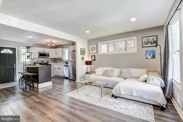 a living room with furniture and kitchen view