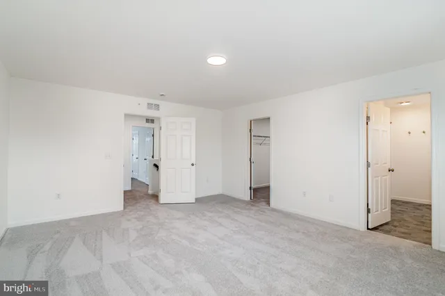 a bathroom with a granite countertop sink a toilet and a mirror