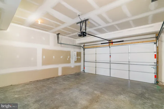 a view of a large white house with a yard