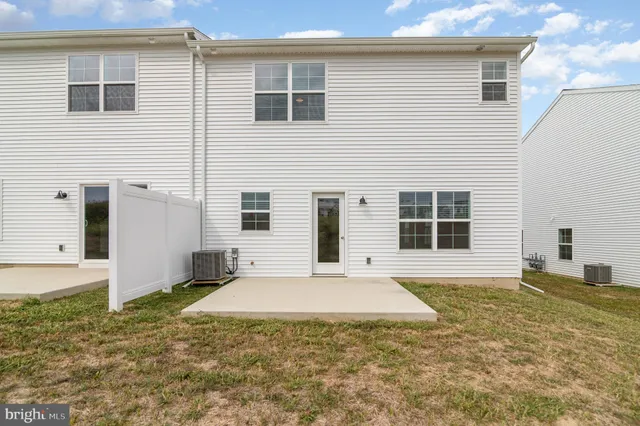 a large white building with trees in front of it