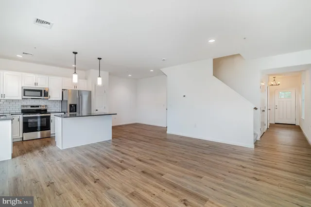 a view of kitchen with wooden floor and electronic appliances