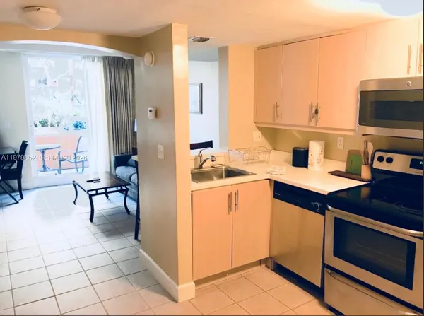 a kitchen with a sink cabinets and appliances