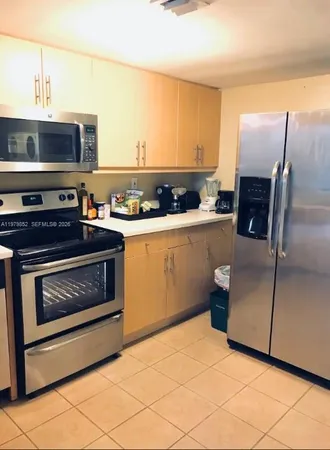 a kitchen with granite countertop a stove and a microwave oven