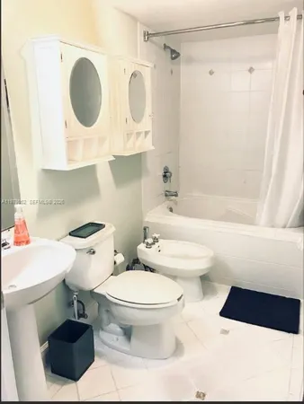 a bathroom with a toilet a sink and a bathtub