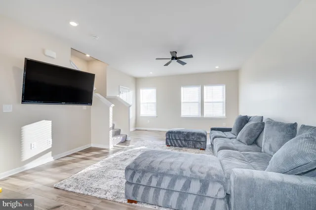 a spacious bedroom with a bed and a flat screen tv
