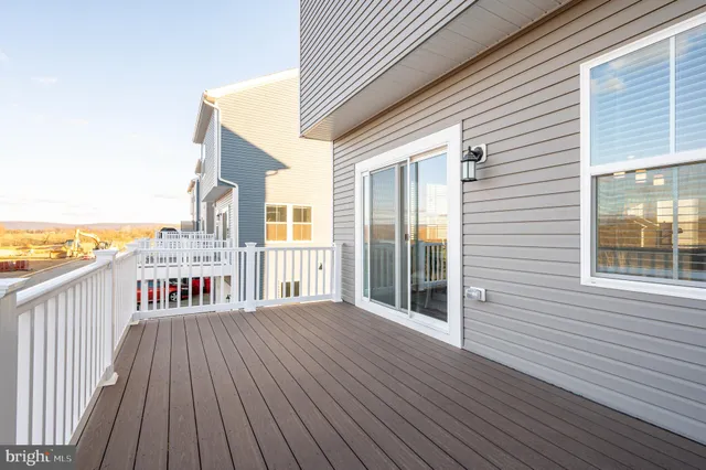 a view of a wooden deck with a yard