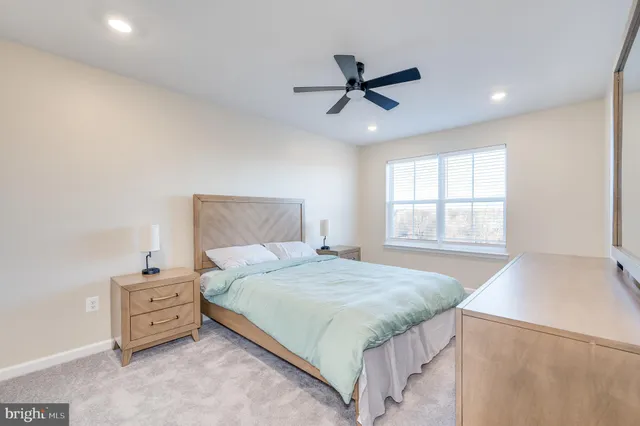 a spacious bedroom with a bed and a chandelier