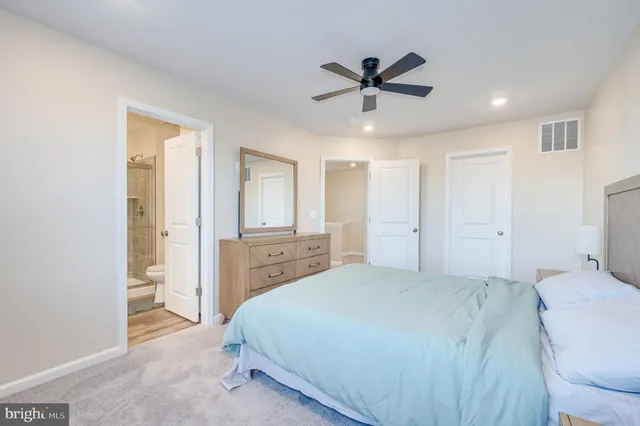a bathroom with a shower sink vanity mirror and toilet