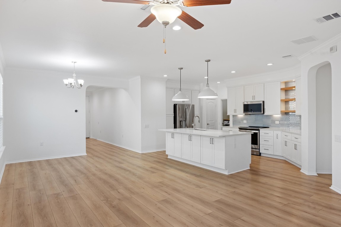 9100 Winter Haven Road Austin, TX 78747 - Photo 11 of 31 a view of kitchen with stainless steel appliances refrigerator stove microwave and cabinets