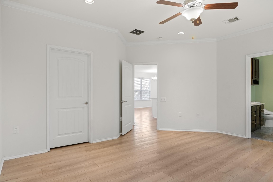 9100 Winter Haven Road Austin, TX 78747 - Photo 13 of 31 an empty room with wooden floor fan and windows