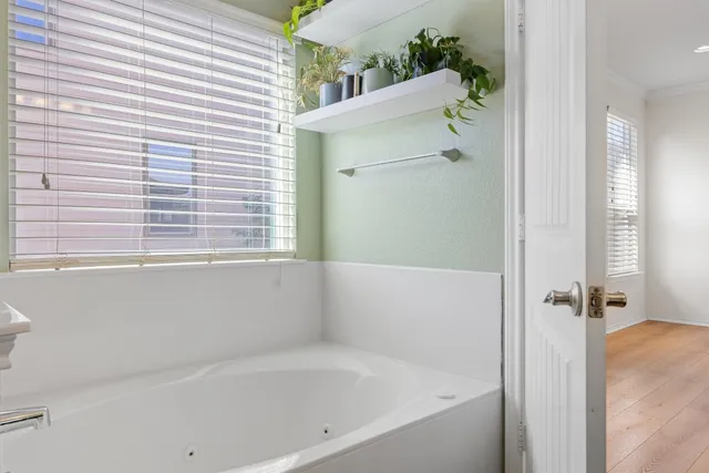 a white bath tub sitting next to a white sink