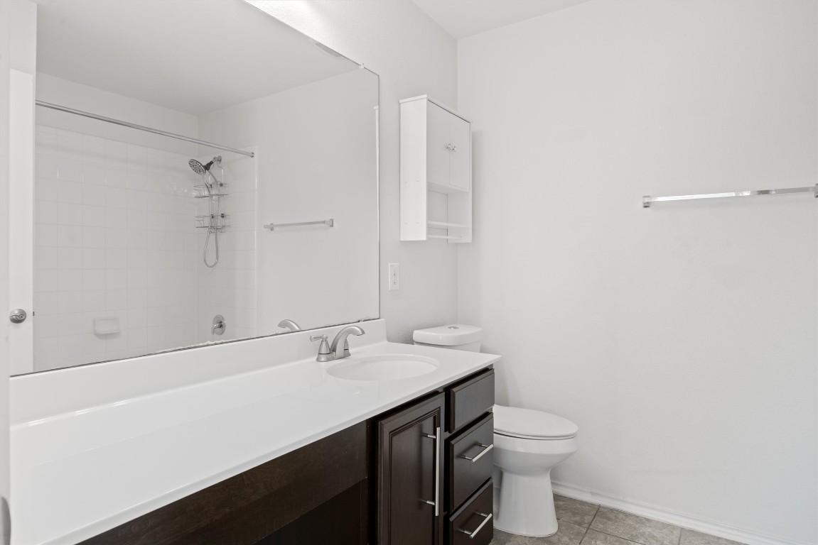 9100 Winter Haven Road Austin, TX 78747 - Photo 21 of 31 a bathroom with a sink a toilet and a mirror