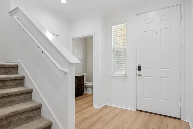 a view of entryway and hall with wooden floor