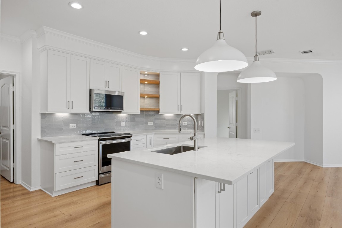 9100 Winter Haven Road Austin, TX 78747 - Photo 6 of 31 a kitchen with stainless steel appliances a sink stove and refrigerator