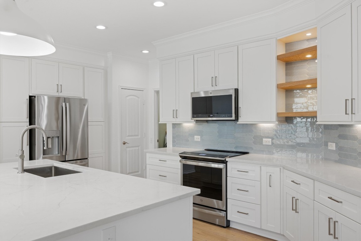 9100 Winter Haven Road Austin, TX 78747 - Photo 8 of 31 a kitchen with stainless steel appliances granite countertop a refrigerator sink and stove