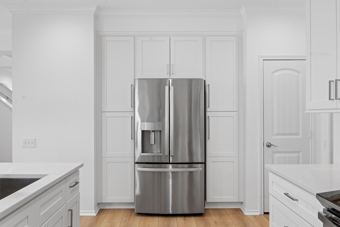 9100 Winter Haven Road Austin, TX 78747 - Photo 9 of 31 a metallic refrigerator freezer sitting in a kitchen