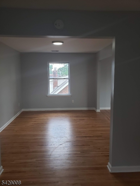 720 Walnut Street Linden, NJ 07036 - Photo 11 of 18 a view of wooden floor and windows in a room
