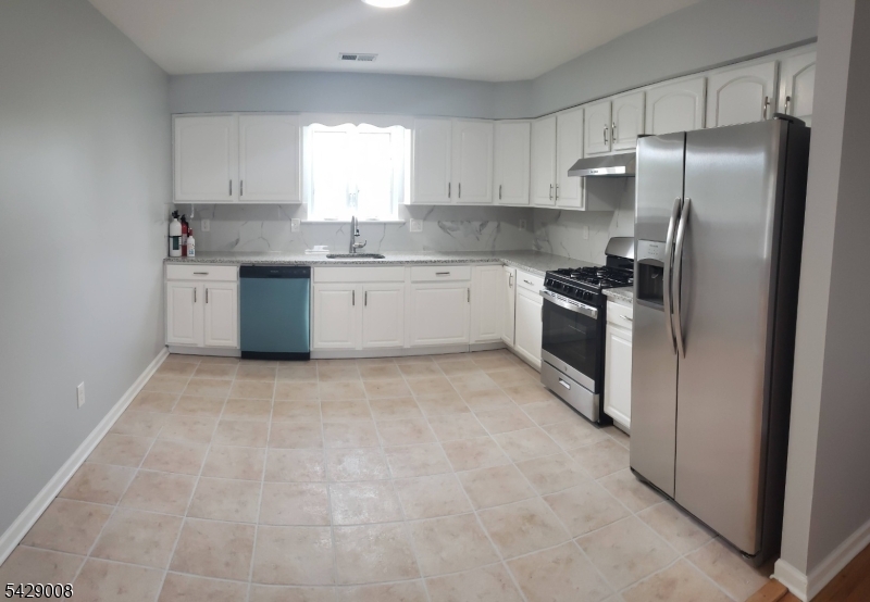 720 Walnut Street Linden, NJ 07036 - Photo 15 of 18 a kitchen with stainless steel appliances granite countertop a refrigerator sink and stove