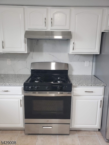 720 Walnut Street Linden, NJ 07036 - Photo 16 of 18 a stove top oven sitting inside of a kitchen