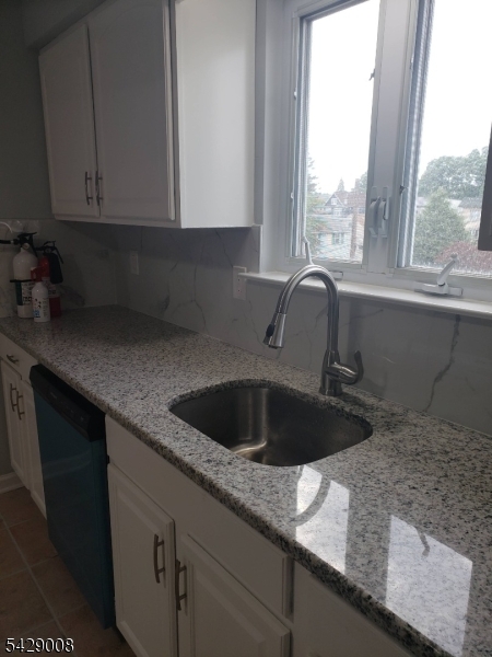 720 Walnut Street Linden, NJ 07036 - Photo 17 of 18 a kitchen with granite countertop a sink and a window