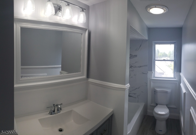 720 Walnut Street Linden, NJ 07036 - Photo 6 of 18 a bathroom with a sink a toilet and shower
