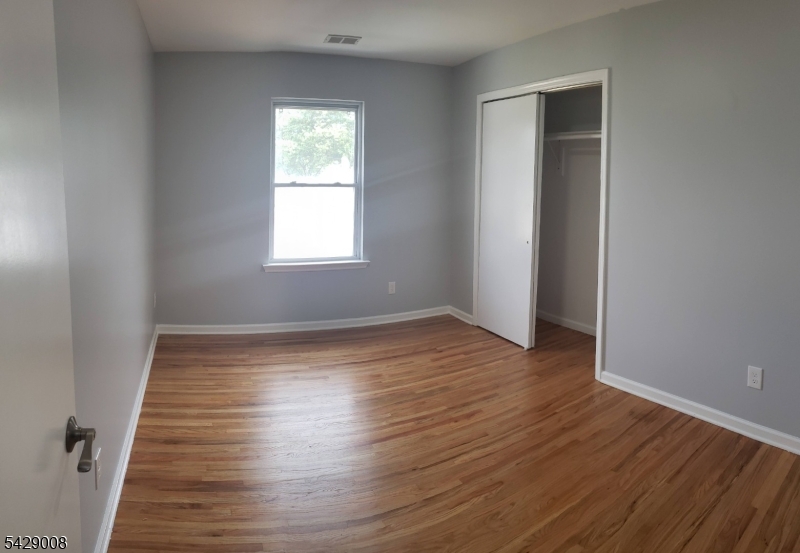 720 Walnut Street Linden, NJ 07036 - Photo 7 of 18 wooden floor in an empty room with a window